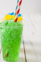 Colorful summer slushies on white wood
