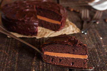 piece of chocolate cake on a dark wooden background