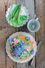 Fototapeta na wymiar Dish with cake and decorative elements from sugar mastic.