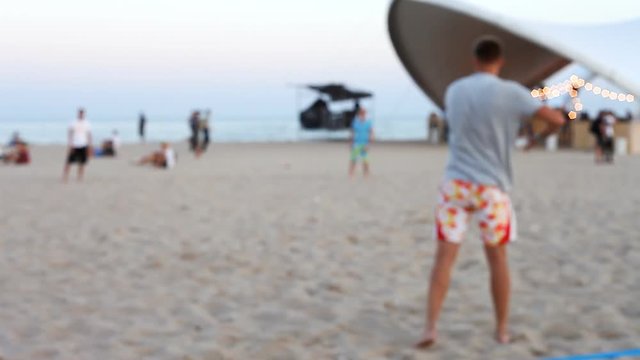 people playing frisbee on the beach