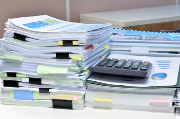 Pile of documents on desk at workplace
