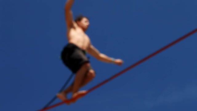 tightrope walking on a high rope stretched