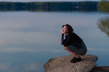 Fototapeta premium pensive girl in the nature near the water