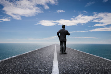 road to future concept with businessman standing on long road