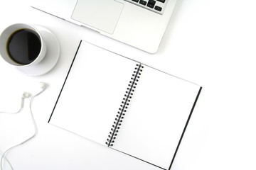 Creative flat lay photo of workspace desk with laptop, earphone, coffee and blank notebook with copy space background, minimal style