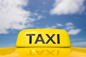 taxi sign with blue sky