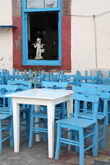 blue wooden chairs and white table in Cunda Island