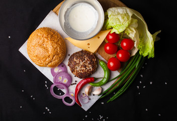 Ingredients for hamburger on a dark background. Top view.
