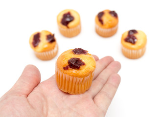 cupcake in hand on a white background