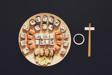 Set of sushi maki and rolls at black background