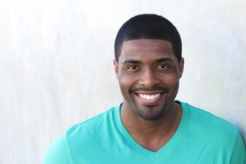 Close up portrait of a handsome young man smiling with copy space 