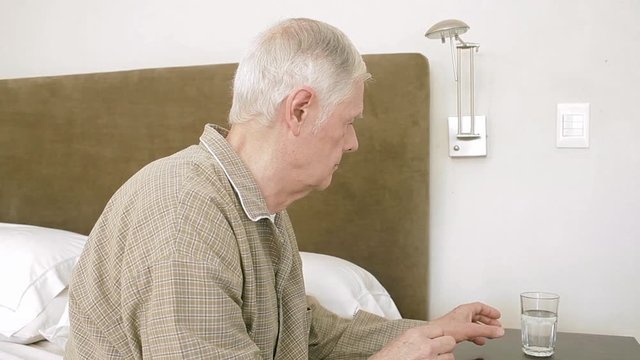Fragile Senior Male Taking Medicine