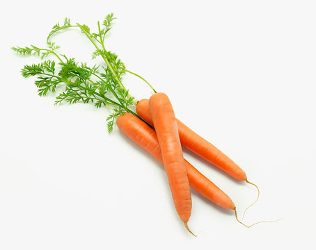 Sweet carrots with leafs isolated on white background