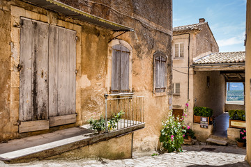 Fototapeta na wymiar Old French village houses and cobblestone street 
