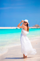 Fototapeta na wymiar Young beautiful woman during tropical beach vacation