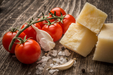 Pecorino and cherry tomatoes on rustic wooden table