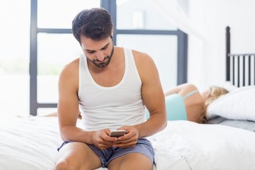 Man text messaging on mobile phone