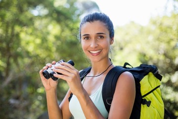 Woman smiling and holding binoculars 