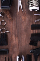 Professional hairdressing equipment on a dark wooden background. Tools for hairdresser, beauty salon.