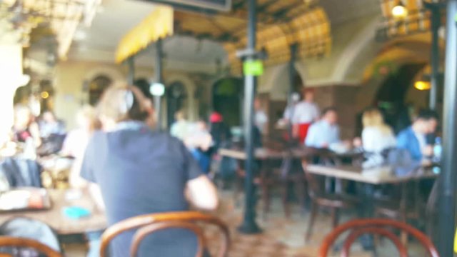 People in restaurant interior, blurred background
