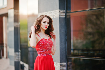 Fototapeta premium Close up portrait of fashionable girl at red evening dress posed