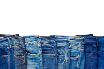 Row of fashion different jeans isolated on white background. - 109730419