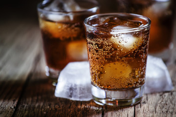 Alcoholic cocktail bourbon cola with whiskey and ice cubes, vint