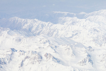 Fototapeta na wymiar Snow on top of the Himalayas mountain range from the airplane window. Bird eyes view 