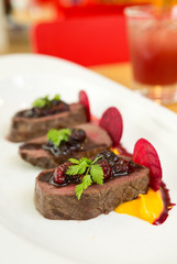 Organic Venison served with fresh raspberry raspberry sauce, beetroot slices and pumpkin puree, on...