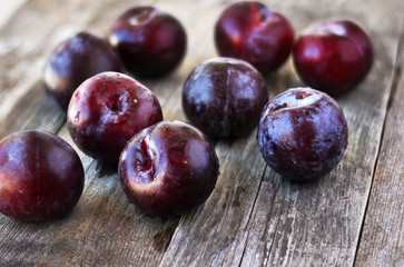 Prunus domestica. Ripe Plums on the wood backgraund.