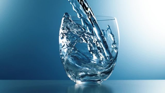 Wasser wird in Glas gesch&uuml;ttet, Zeitlupe, blauer Hintergrund
