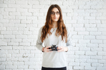 woman photographer holding a film camera in hands