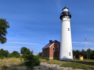 Fototapeta na wymiar Scenic northern Michigan white lighthouse in summer evening sunlight