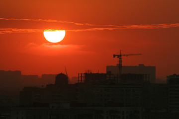 Fototapeta premium Back light construction site silhouetted at sunset