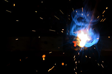 Fototapeta na wymiar Drop of molten iron and sparks
