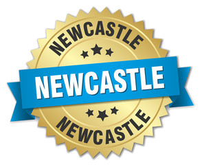 Newcastle round golden badge with blue ribbon