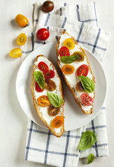 Croissant with tomato, basil and cream cheese. Top view