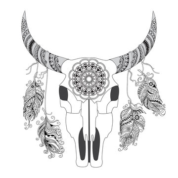 Decorated Cow Skull isolated on white with mandala and feathers