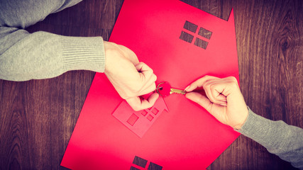 People exchanging house keys.