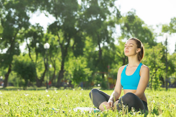 Naklejka na ściany i meble Woman meditating in park