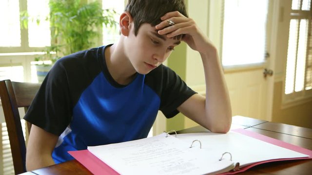 A teenage boy struggling with his homework.