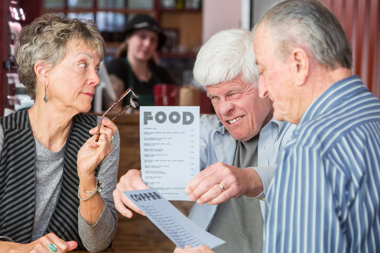 Mature Man Struggles to Read Menu Without Glasses