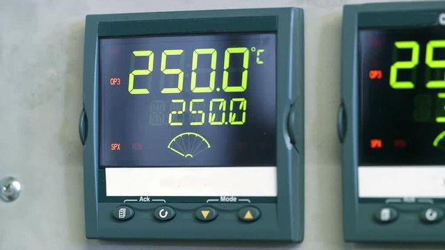 Information blinks and changes on the digital displays of a programmable logic control panel.