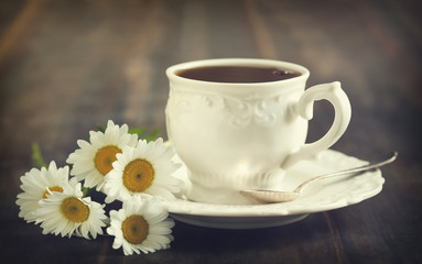 Cup of tea and chamomiles