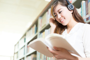 young beautiful asian girl university student in library