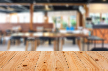 Selected focus empty brown wooden table and Coffee shop blur bac