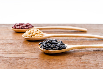 Fototapeta na wymiar Soy beans, Kidney beans, black beans on dark wooden background
