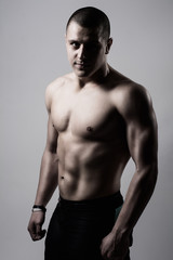 Fototapeta premium Portrait of a handsome muscular young man. Shot in a studio.
