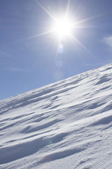 slope with beautiful bright sun. snowy slope. the bright sun on a slope.