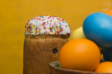 Easter eggs of different colors and cake